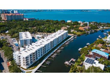 Aerial view of waterfront community with modern building and boat slips at 1709 N Tamiami Trl # A421, Sarasota, FL 34234