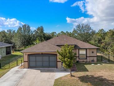 Charming single-story home with a fenced yard and attached two-car garage at 279 Hutchins St, Port Charlotte, FL 33953