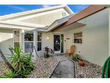 Inviting front entry with walkway, landscaping, and charming door at 805 Harrington Lake N Dr # 76, Venice, FL 34293
