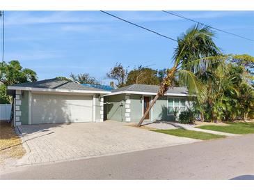 Charming single-story home with attached garage and lush landscaping at 1220 26Th W St, Bradenton, FL 34205