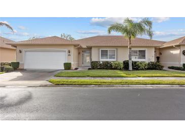 Well-maintained house with a garage and palm tree landscaping at 24181 Green Heron Dr # 84, Punta Gorda, FL 33980