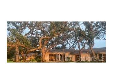 Inviting single-story home with mature trees and well-manicured lawn at 3350 Old Oak Dr, Sarasota, FL 34239