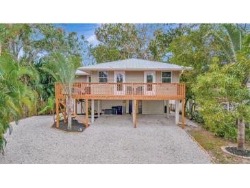 Elevated home with large deck and fenced yard at 4530 Murdock Ave, Sarasota, FL 34231