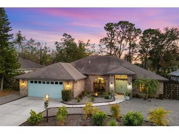 Attractive single-story home with a light-blue garage door and landscaping at 5706 Bent Oak Dr, Sarasota, FL 34232