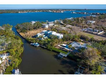 Aerial view of waterfront property with modern home and private dock at 1221 S Basin Ln, Sarasota, FL 34242