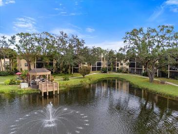 Beautiful community featuring a serene pond with fountain and gazebo at 305 30Th W Ave # A208, Bradenton, FL 34205