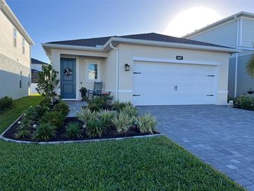 House exterior featuring a two-car garage and well-manicured landscaping at 4627 Pippin Ln, Bradenton, FL 34211