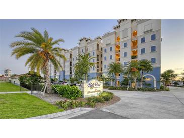 Inviting condo building with lush landscaping and a welcoming entrance at 505 Tamiami N Trl # 201, Venice, FL 34285