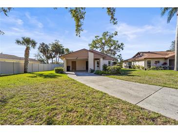 Charming single-story home featuring a well-manicured lawn and covered carport at 5111 26Th St. Ct, W # 53, Bradenton, FL 34207