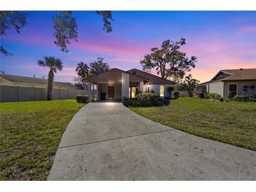 Charming home with a well-manicured lawn and a spacious driveway under a colorful evening sky at 5111 26Th St. Ct, W # 53, Bradenton, FL 34207
