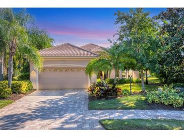 Beautiful home with a well-manicured lawn and a paved driveway at 7443 Riviera Cv, Lakewood Ranch, FL 34202