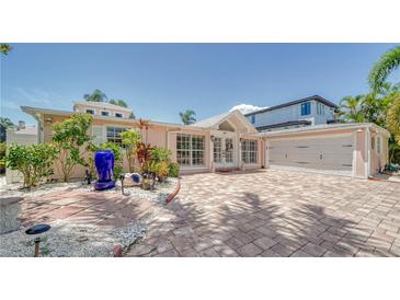 Attractive single-story home with a paved driveway and landscaped front yard at 747 Marbury Ln, Longboat Key, FL 34228