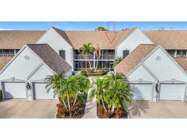 Front view of condo building showcasing attractive landscaping and building architecture at 6609 Stone River Rd # 104, Bradenton, FL 34203