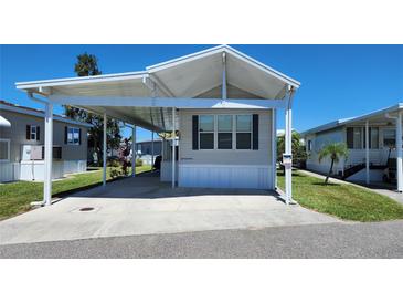 Charming single-story home with covered parking and well-maintained landscaping under a clear blue sky at 3333 26Th E Ave # 1107, Bradenton, FL 34208