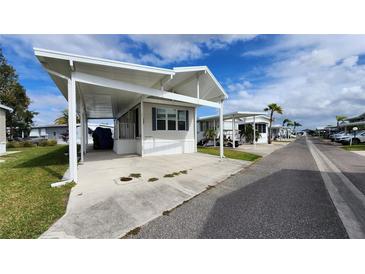 Exterior view of a mobile home with a covered carport and driveway at 3333 26Th E Ave # 1107, Bradenton, FL 34208