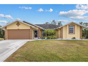 Attractive single-story home with a two-car garage and landscaped front yard at 5105 Bannock Cir, North Port, FL 34288