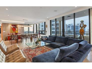 Open-concept living room featuring floor to ceiling windows and modern decor at 1255 N Gulfstream Ave # Ph1501, Sarasota, FL 34236