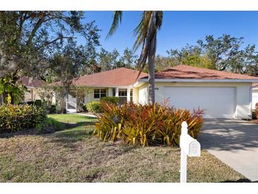 Charming one-story home with attached garage and lush landscaping at 3424 Brookridge Ln, Parrish, FL 34219