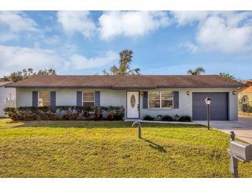 Charming single-story home with a well-manicured lawn and landscaping at 4064 Velarde Ln, Sarasota, FL 34235