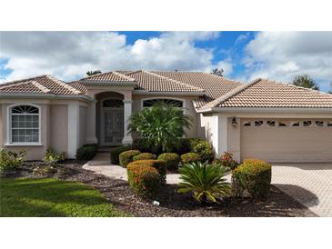 Well-maintained house featuring a tile roof and lush landscaping at 4669 Sweetmeadow Cir, Sarasota, FL 34238