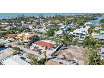 Aerial view of a home under construction in a neighborhood with canals at 579 Bayview Dr, Longboat Key, FL 34228