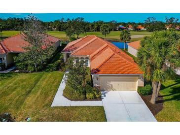 Charming single-story home with a tile roof, landscaped yard, and attached garage at 616 Misty Pond Ct, Bradenton, FL 34212