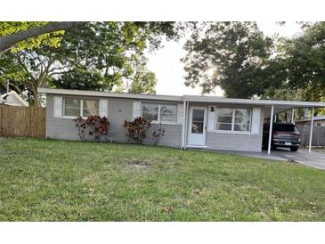 Ranch style home with carport and well-maintained lawn at 9596 Groveland St, Seminole, FL 33772