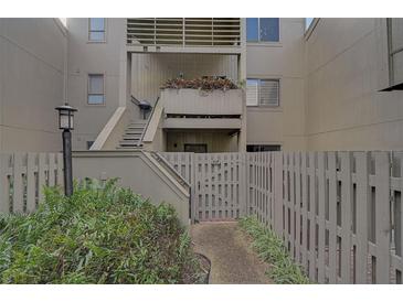 Private entrance to a condo with stairs leading to the second floor and lush landscaping at 109 Woodland Pl, Osprey, FL 34229