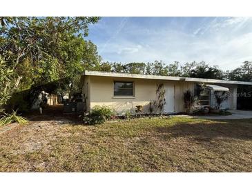 Single-story home with a front yard and some landscaping at 4442 Beacon Dr, Sarasota, FL 34232