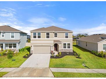 Two-story house with a neutral color scheme and a two-car garage at 5316 Rocky Coast Place, Palmetto, FL 34221