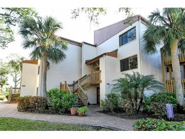 Building exterior showcasing landscaping and entrance at 1700 Cove Ii Pl # 311, Sarasota, FL 34242