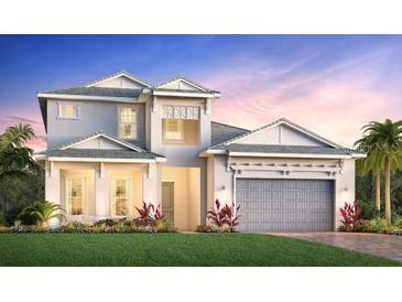 Two-story home with a gray and white exterior, gray tiled roof, and a two-car garage at 17919 Palmiste Dr, Bradenton, FL 34202