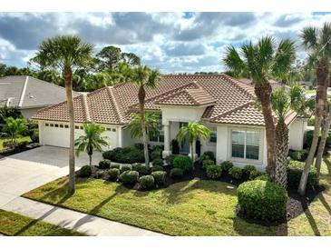 Beautiful home featuring a tile roof, landscaped yard and an attached two car garage at 2112 Calusa Lakes Blvd, Nokomis, FL 34275