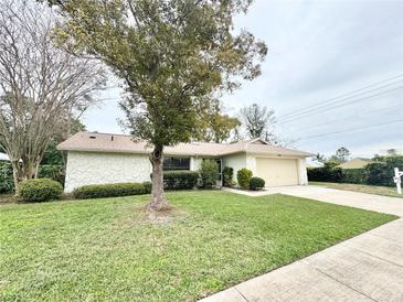 Charming single-story home featuring a well-maintained lawn and an attached one car garage at 1416 Glenmere Dr, Brandon, FL 33511