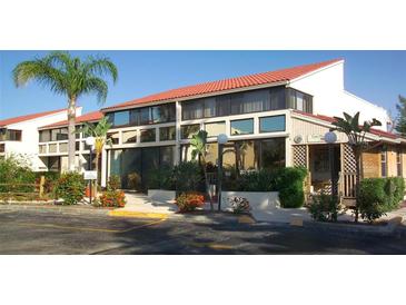 Attractive building exterior with lush landscaping and inviting entryway at 4621 Gulf Of Mexico Dr # 16B, Longboat Key, FL 34228