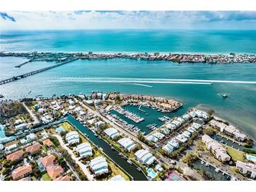 Aerial view of waterfront community with marina, pool, and tennis courts at 4003 129Th W St # 101, Cortez, FL 34215