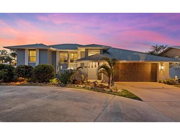 Stunning waterfront home with a modern design, beautifully landscaped yard, and a charming curb appeal at 609 Elba Dr, Nokomis, FL 34275