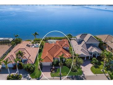 Luxury waterfront home with private pool and lush landscaping at 805 Riviera Dunes Way, Palmetto, FL 34221