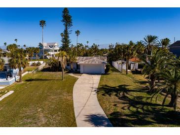 Aerial view of a single-story home with a private dock and lush landscaping at 15815 Redington Dr, Redington Beach, FL 33708