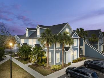 Two-story townhome with gray siding, white trim, and palm trees at 5560 Rosehill Rd # 201, Sarasota, FL 34233