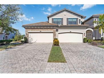 Two-story home with three-car garage and paver driveway at 5830 Wake Forest Run # 102, Bradenton, FL 34211