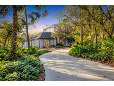 Luxury home with circular driveway, lush landscaping, and a private setting at 6700 S Gator Creek Blvd, Sarasota, FL 34241