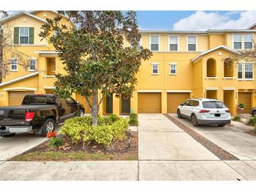 Two-story townhome with two-car garage and landscaped front yard at 7325 Black Walnut Way, Lakewood Ranch, FL 34202