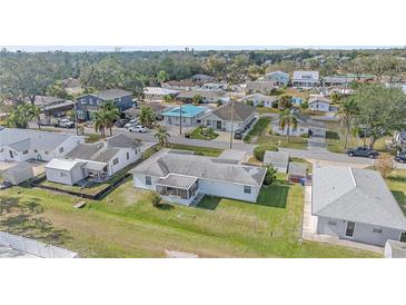 Aerial view of a single-Gathering home with a large backyard and surrounding neighborhood at 1521 Graber Ave, Sarasota, FL 34239