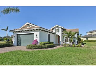 Single-story house with a two-car garage and well-manicured lawn at 5060 Lake Overlook Ave, Bradenton, FL 34208