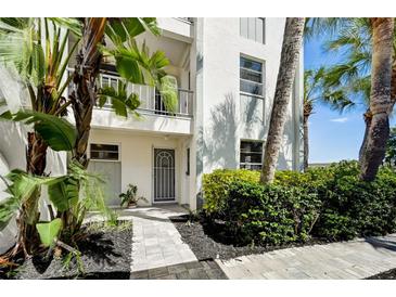 Inviting condo entry with a well-maintained walkway and landscaping at 4330 Falmouth Dr # 108, Longboat Key, FL 34228