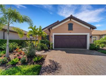 Single-story home with brown garage door and landscaping at 5341 Popoli Way, Sarasota, FL 34238