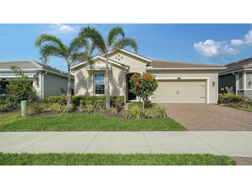 One-story home with attractive landscaping and a two-car garage at 5436 Hope Sound Cir, Sarasota, FL 34238
