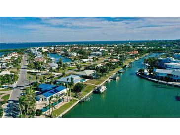 Beautiful aerial view of a waterfront community with canals leading to the bay at 6011 Emerald Harbor Dr, Longboat Key, FL 34228