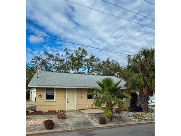 Tan house with palm trees and a gravel driveway at 4706 3Rd W Ave, Bradenton, FL 34209